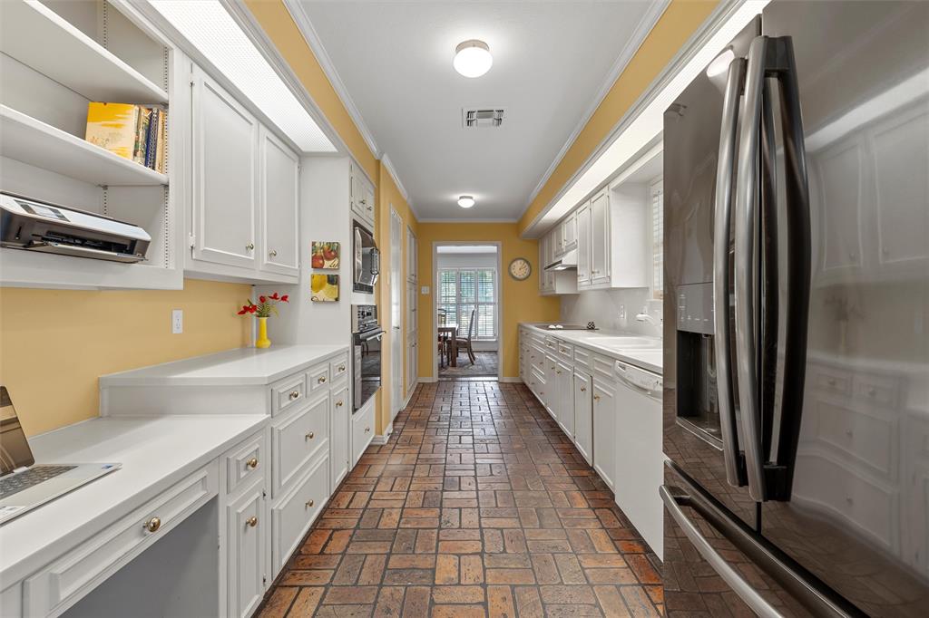 3907 Old Mill Road Waco, TX 76710 - Photo 9 of 30 a large white kitchen with stainless steel appliances granite countertop a lot of counter space and a window