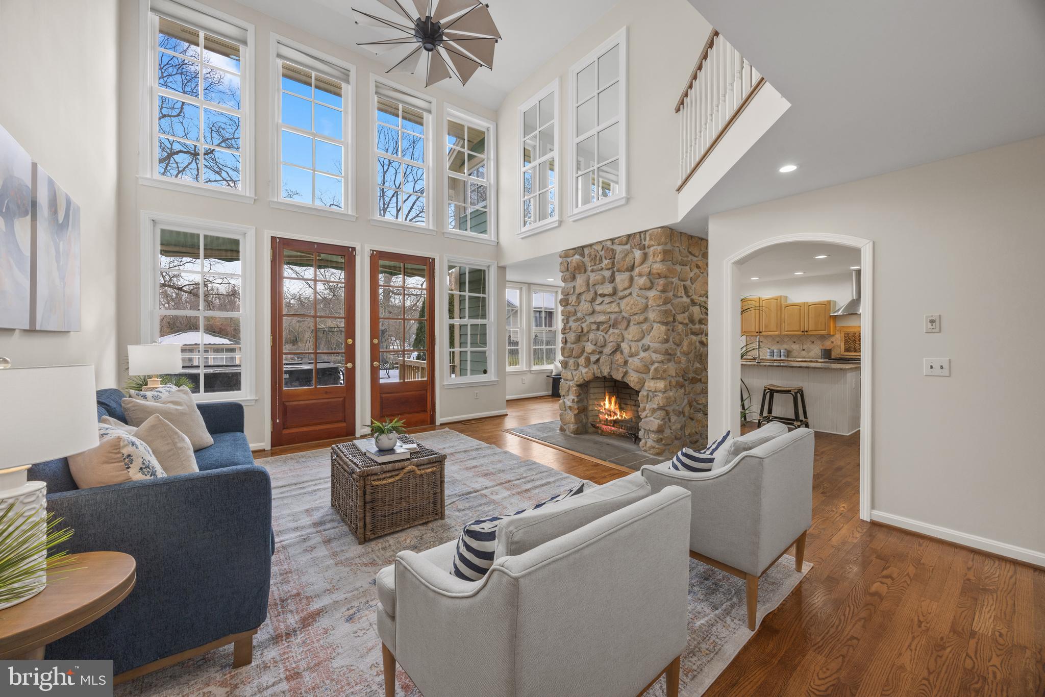 Stunning waterside Living room w/ stone fireplace