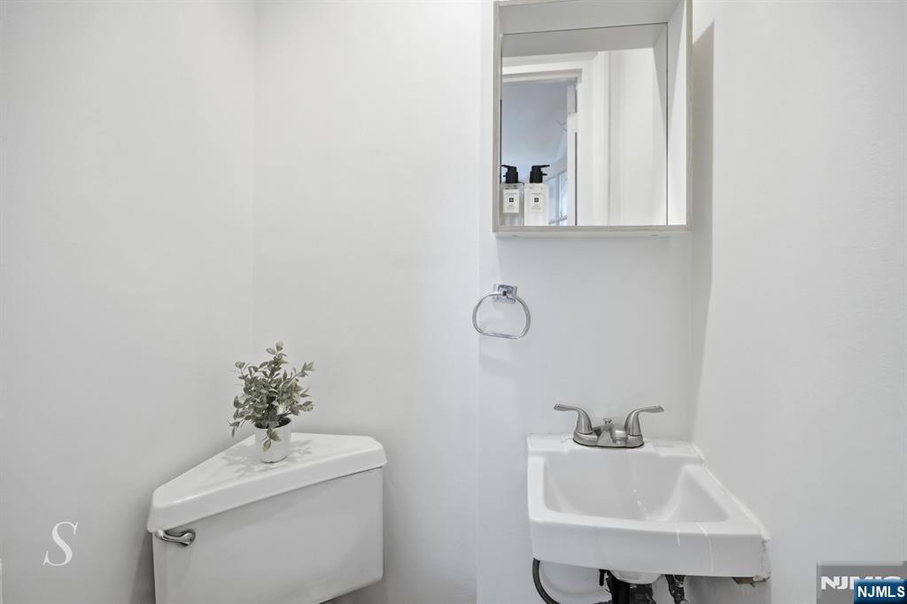 440 Kinderkamack Road River Edge, NJ 07661 - Photo 16 of 31 a bathroom with a sink toilet and a mirror