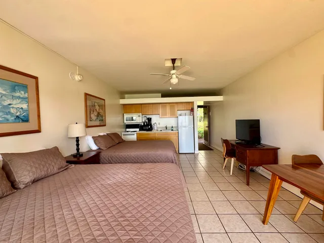 a bedroom with furniture and a flat screen tv