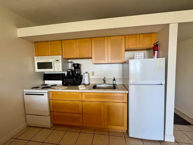 a kitchen with a refrigerator sink stove and cabinets