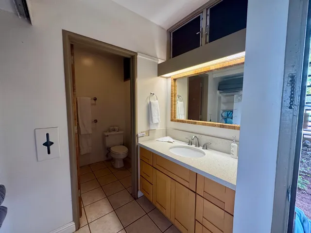 a spacious bathroom with a double vanity sink toilet and shower