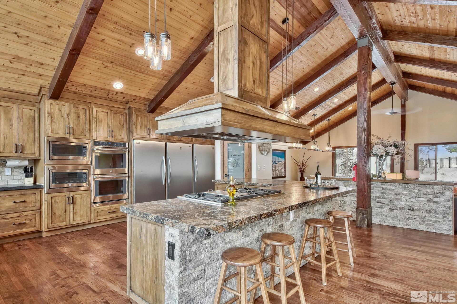 333 Ute Way Stateline, NV 89449 - Photo 11 of 40 a kitchen with stainless steel appliances kitchen island granite countertop a sink and cabinets