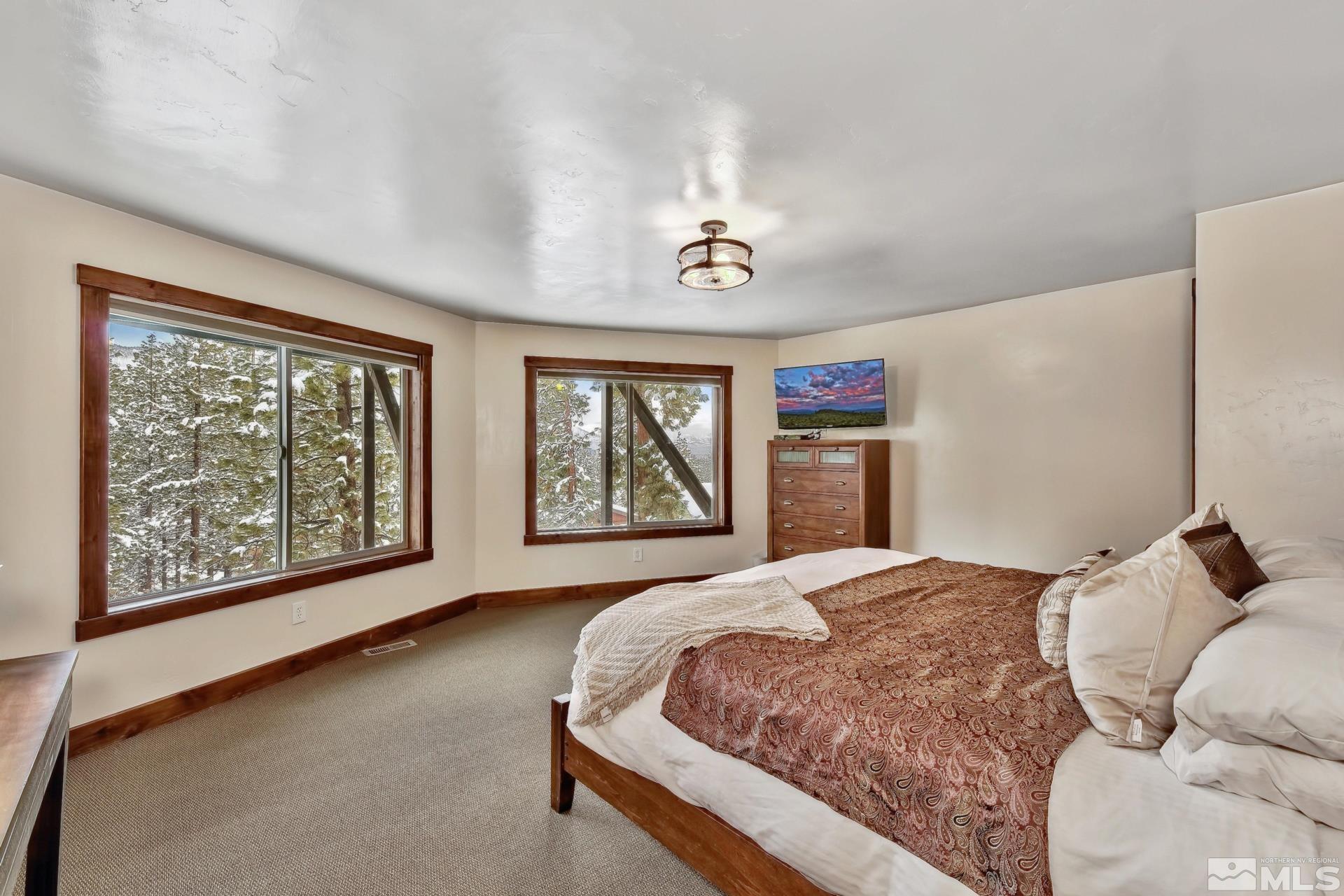 333 Ute Way Stateline, NV 89449 - Photo 24 of 40 a spacious bedroom with a large bed and a window