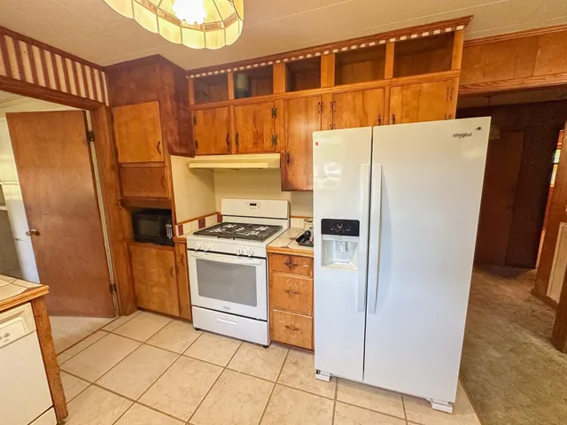a kitchen with a refrigerator and a stove