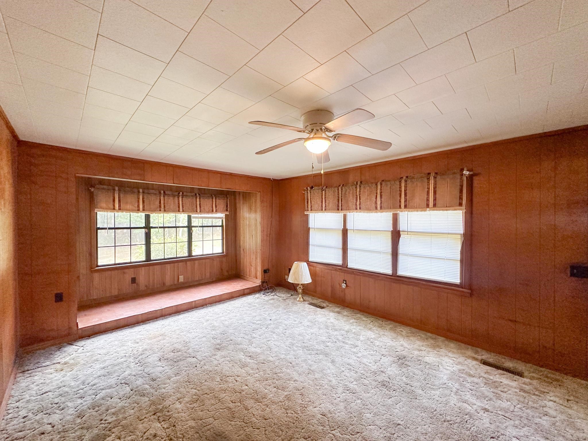 11 Cr 958 Road Tishomingo, MS 38873 - Photo 4 of 11 an empty room with chandelier fan and windows