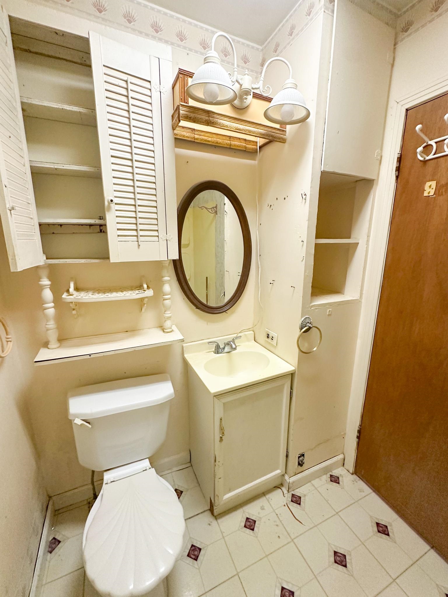 11 Cr 958 Road Tishomingo, MS 38873 - Photo 9 of 11 a bathroom with a toilet sink and mirror