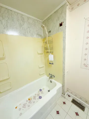 a bathroom with a bathtub and shower