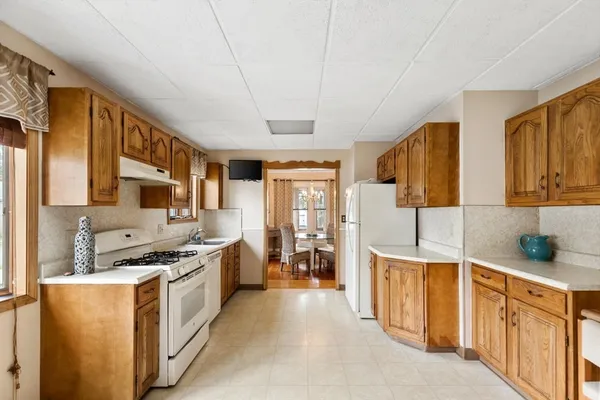 a kitchen with stainless steel appliances a sink stove and cabinets