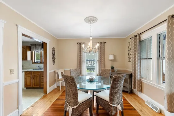 a view of a dining room with furniture window and wooden floor