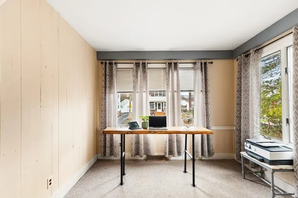 a bedroom with furniture and large window