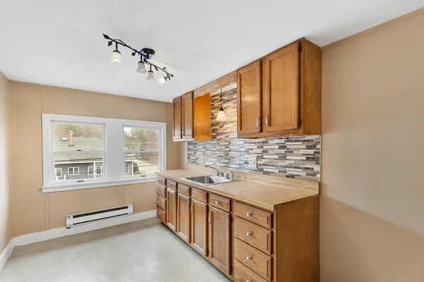 a bathroom with a sink a vanity and a large mirror