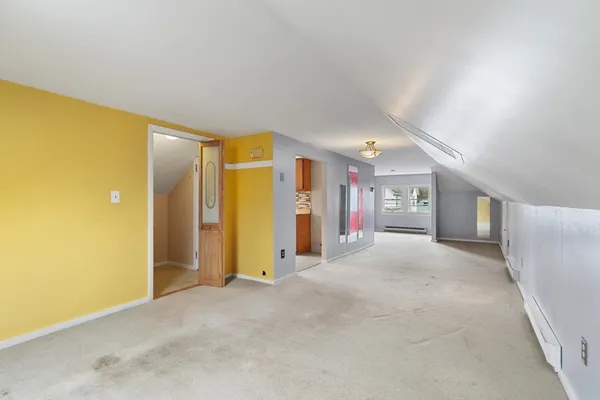 a view of a livingroom with furniture and an entryway