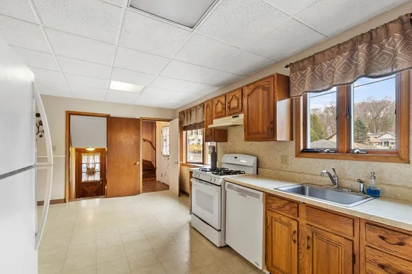 a kitchen with a sink cabinets and refrigerator