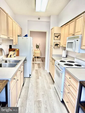 a kitchen with stainless steel appliances a stove a sink and a refrigerator