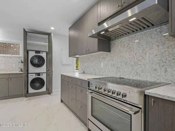 a stove top oven sitting inside of a kitchen