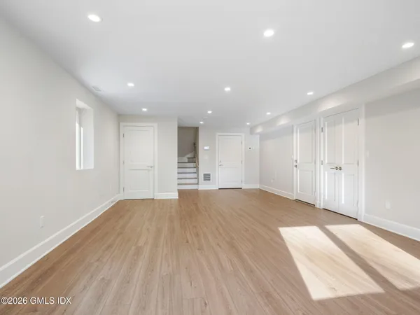 a view of an empty room with wooden floor