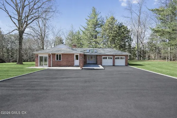 a view of a house with a yard and garage
