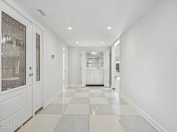 a view of a hallway with wooden shelves