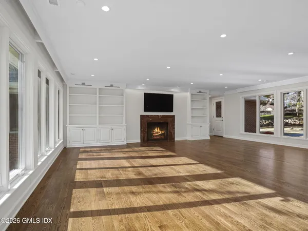 a view of a livingroom with a hall and wooden floor