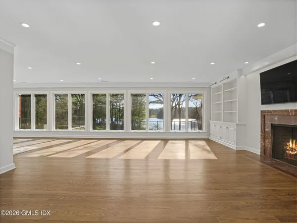 a view of an empty room with a fireplace and a window