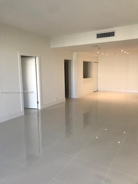 251 Crandon Boulevard, Unit 535 Key Biscayne, FL 33149 - Photo 3 of 14 an empty room with wooden floor and windows