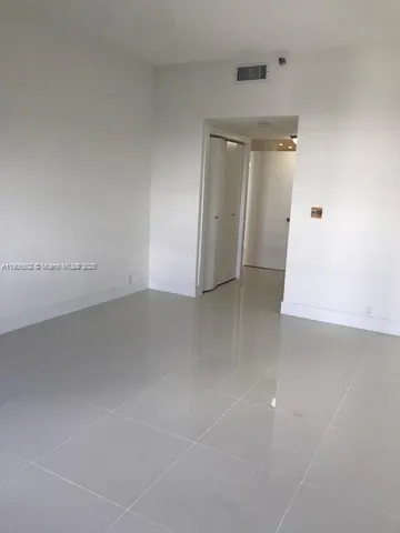 an empty room with an entrance to other room