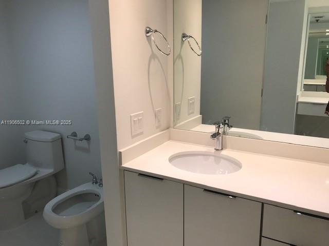 251 Crandon Boulevard, Unit 535 Key Biscayne, FL 33149 - Photo 8 of 14 a bathroom with a sink toilet and a mirror