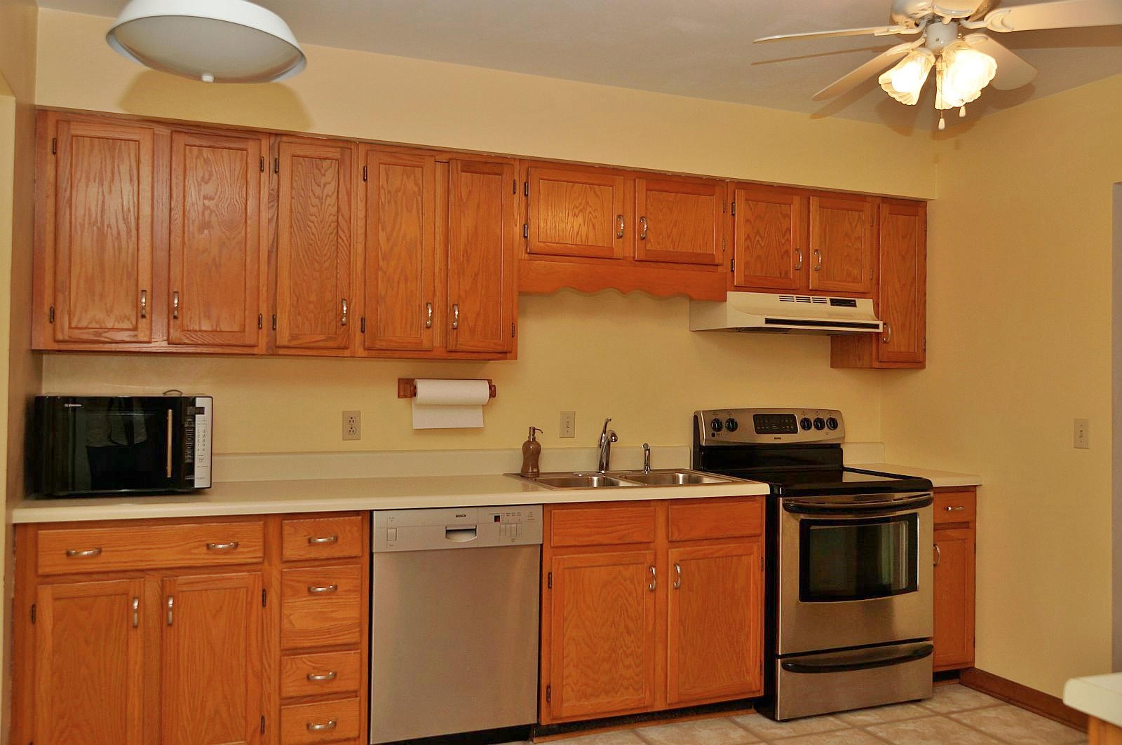 35 Oak Leaf Drive Blue Ridge, VA 24064 - Photo 12 of 36 a kitchen with stainless steel appliances granite countertop a stove a sink dishwasher and a microwave oven with wooden cabinets