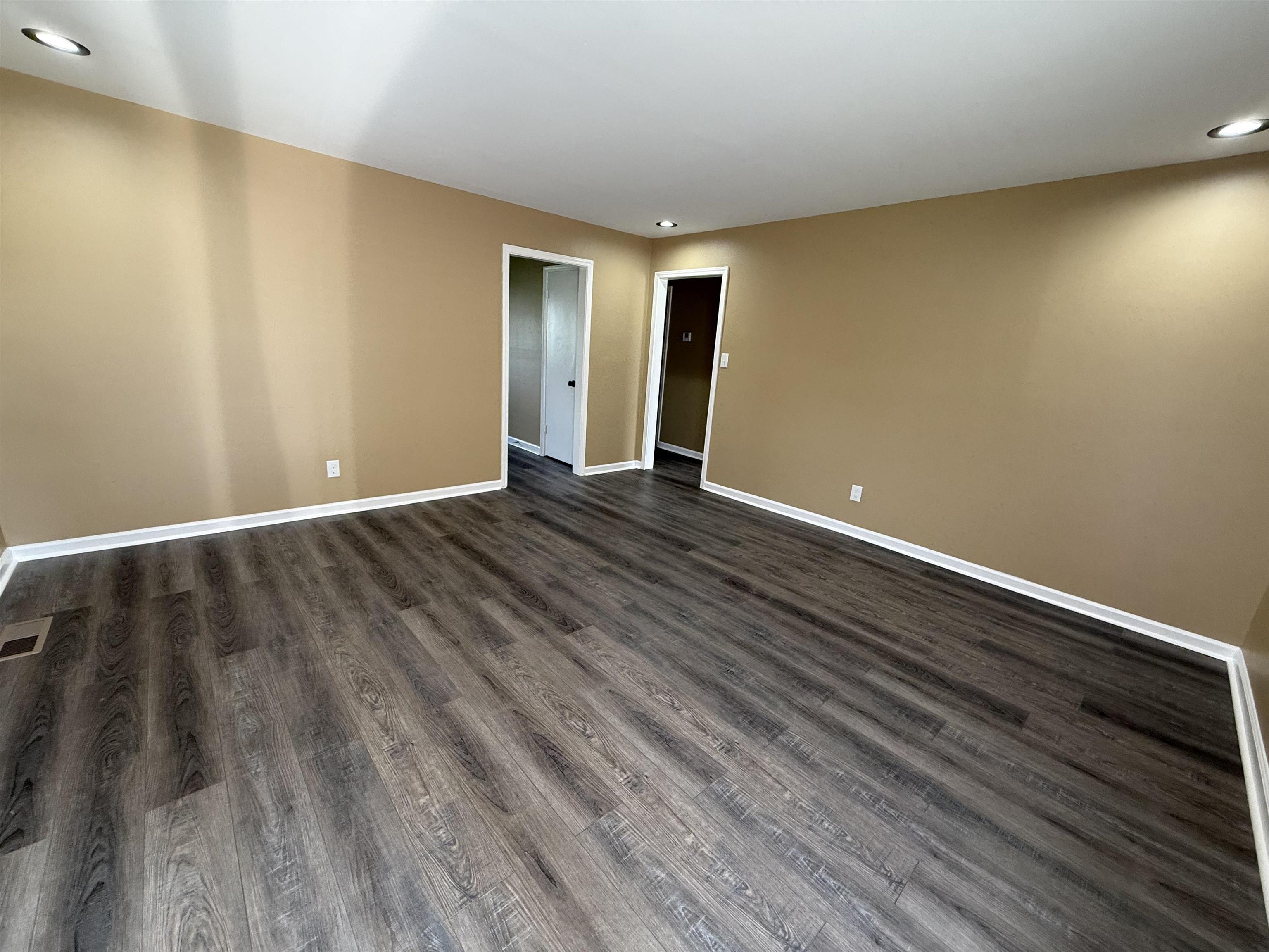 62 Cinnamon Drive, Unit LEFT Jackson, TN 38305 - Photo 2 of 8 a view of an empty room with wooden floor