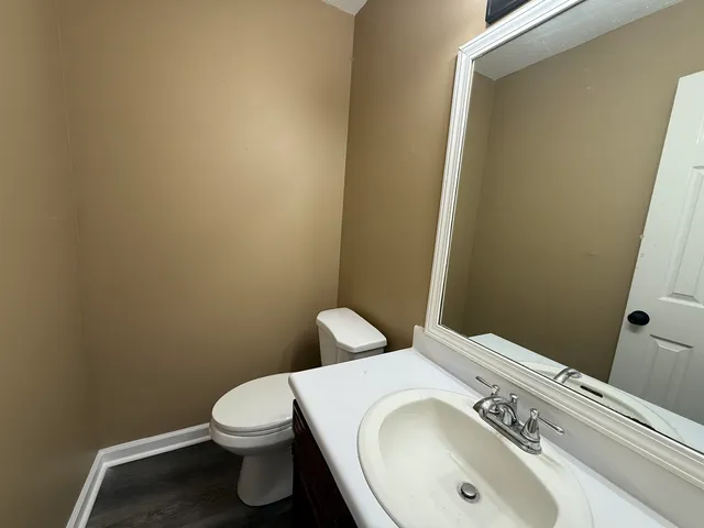 a white toilet sitting next to a bathroom sink