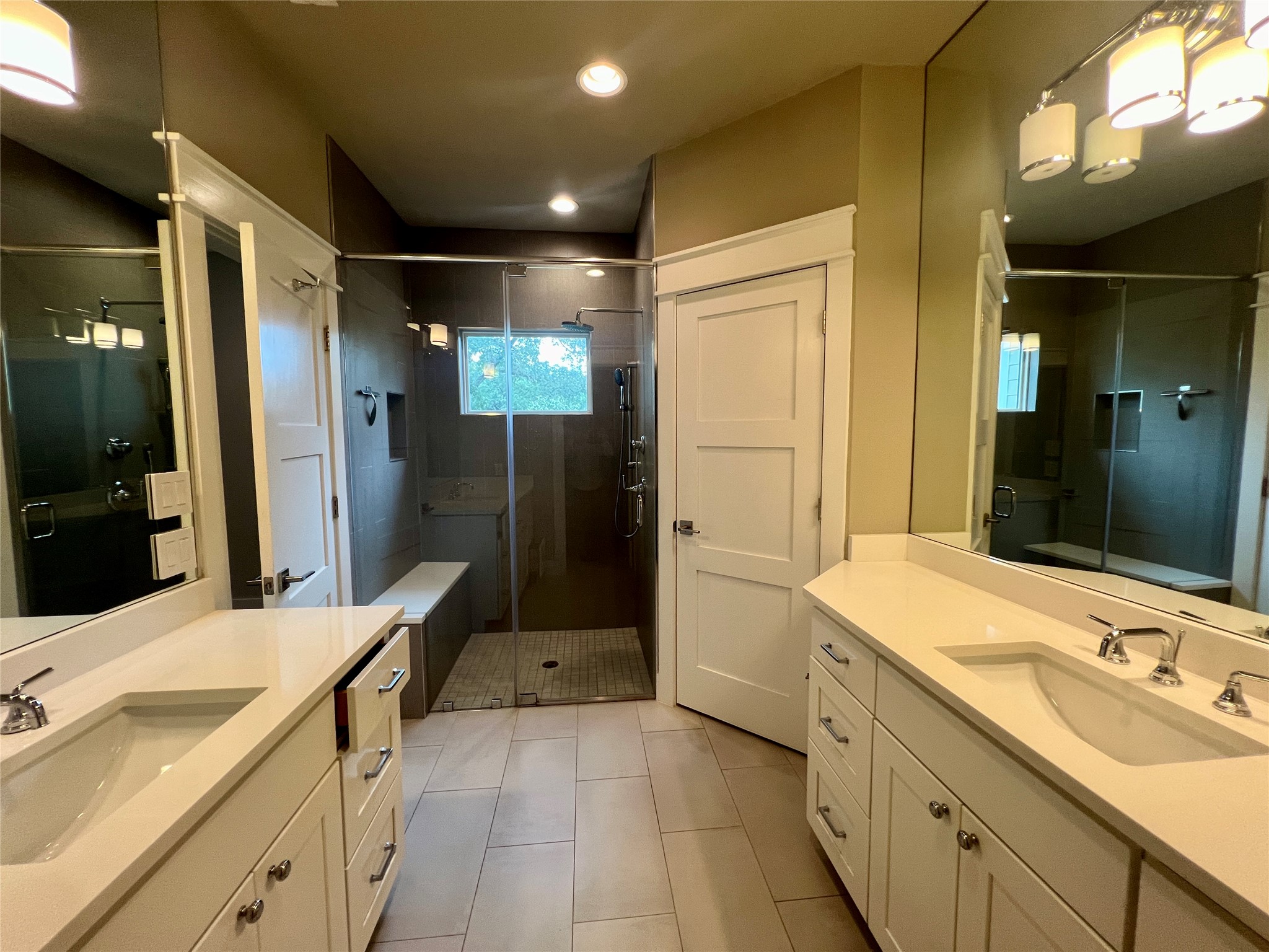 6515 Davis Lane, Unit 10 Austin, TX 78749 - Photo 14 of 22 Dual vanities and a spacious walk-in shower elevate this contemporary primary bathroom.