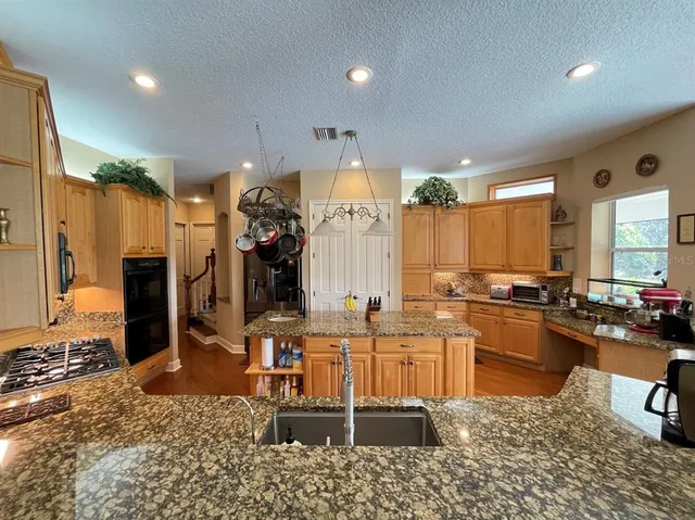 a kitchen with lots of counter top space and living room