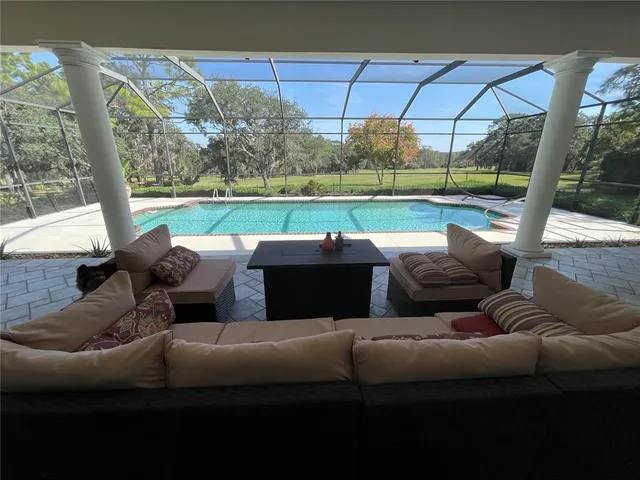 a couch sitting in a yard and sitting area