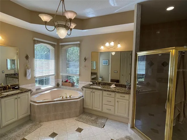 a white toilet sitting next to a bathroom sink and vanity