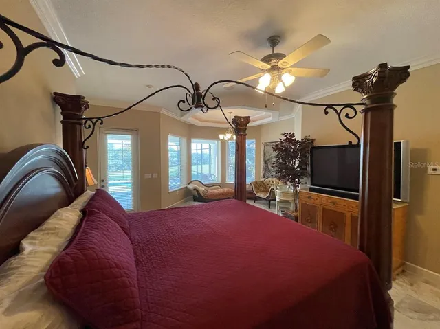 a bedroom with a bed window and couch