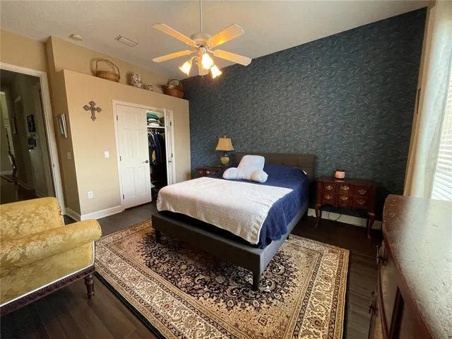 a bathroom with a granite countertop sink toilet and mirror