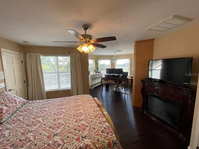 a room with furniture a bookshelf and a window