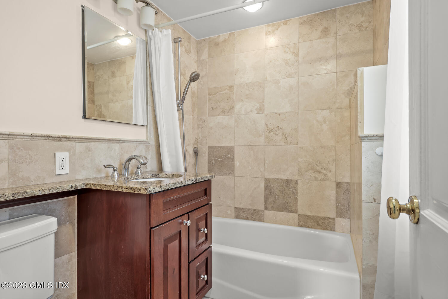 5 Linwood Avenue Riverside, CT 06878 - Photo 10 of 16 a bathroom with a granite countertop sink a mirror a bathtub and shower