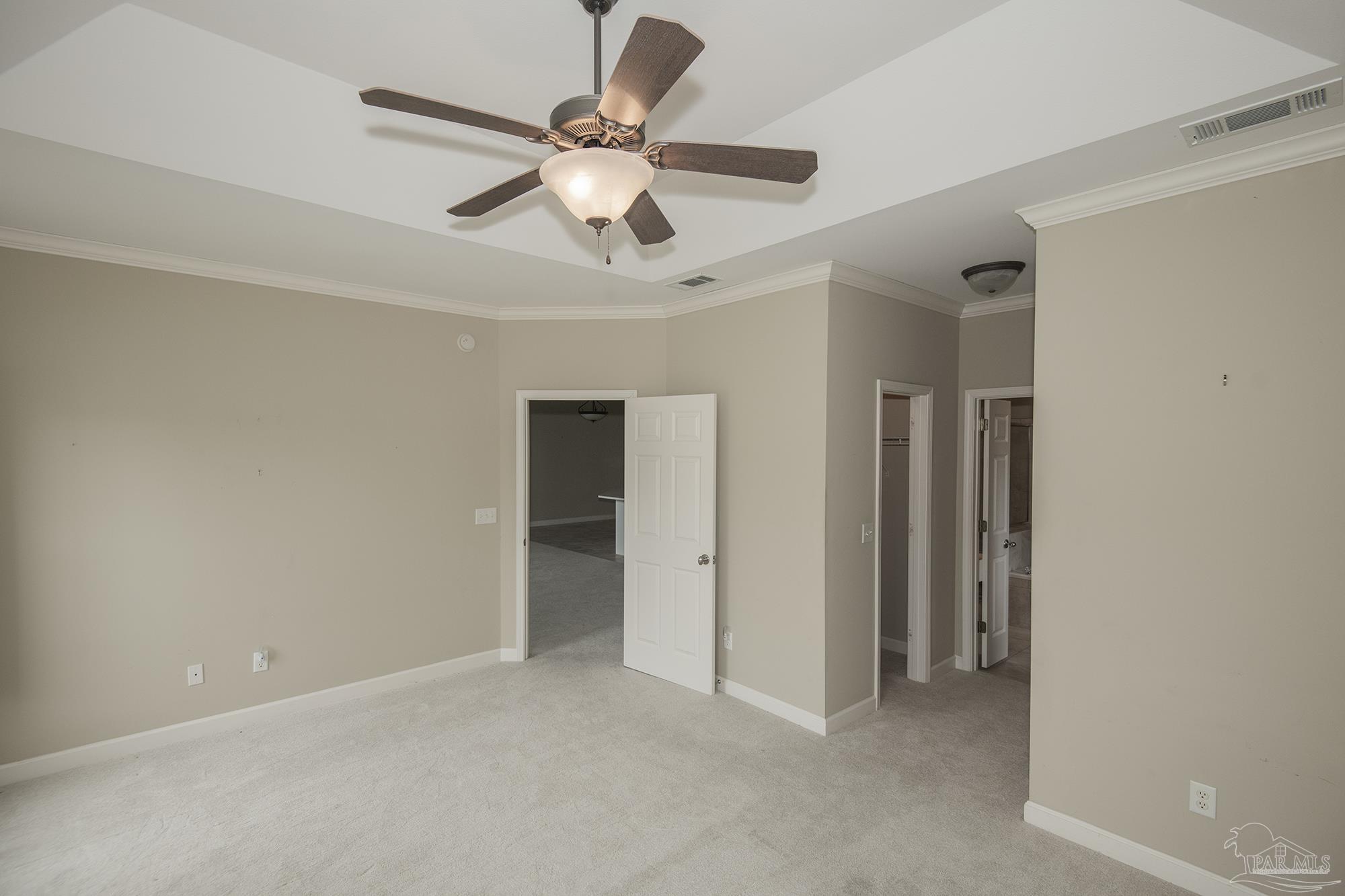 3200 Silverleaf Drive Pensacola, FL 32504 - Photo 17 of 38 an empty room with chandelier fan and windows