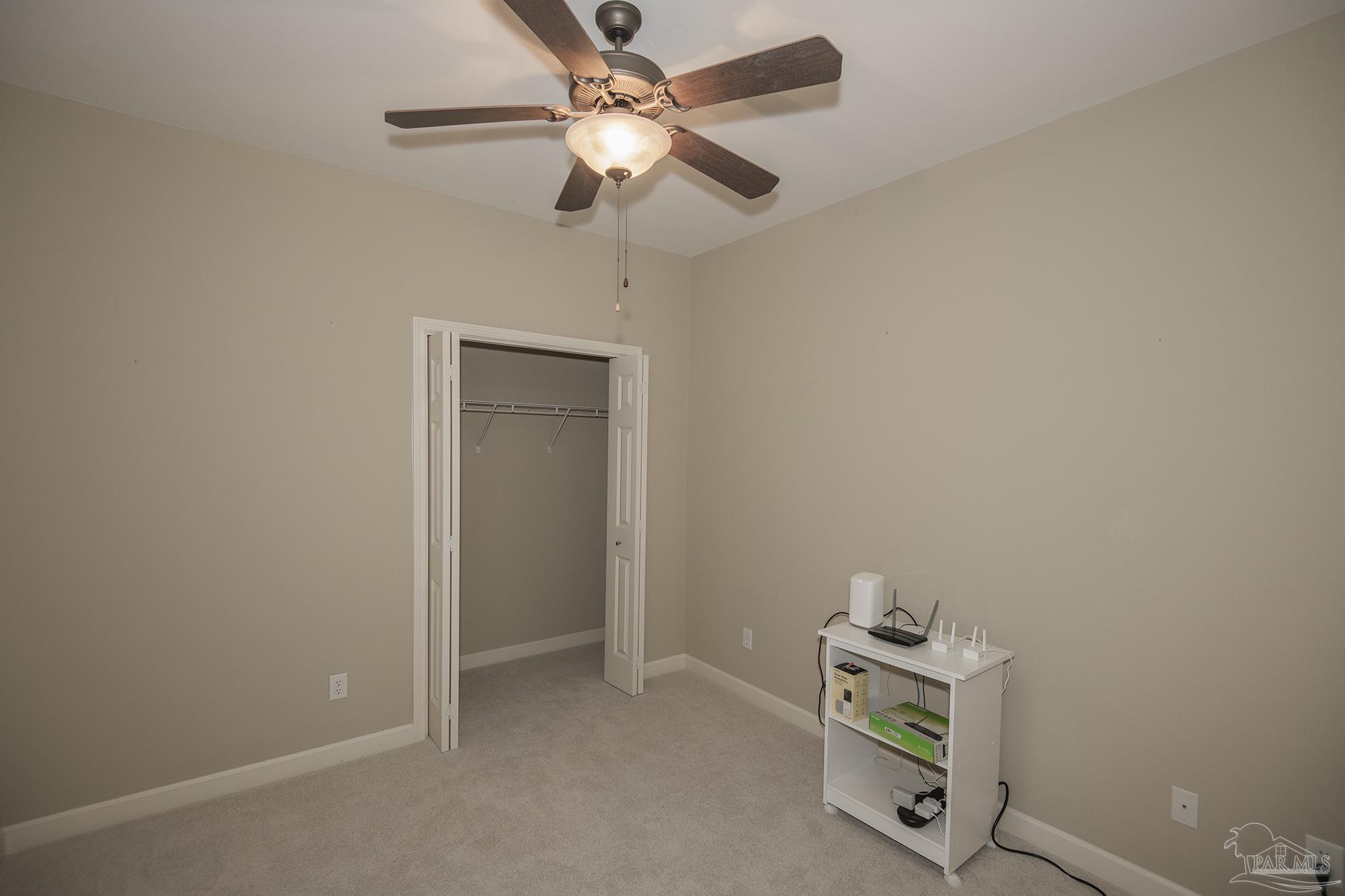 3200 Silverleaf Drive Pensacola, FL 32504 - Photo 25 of 38 an empty room with a window and ceiling fan