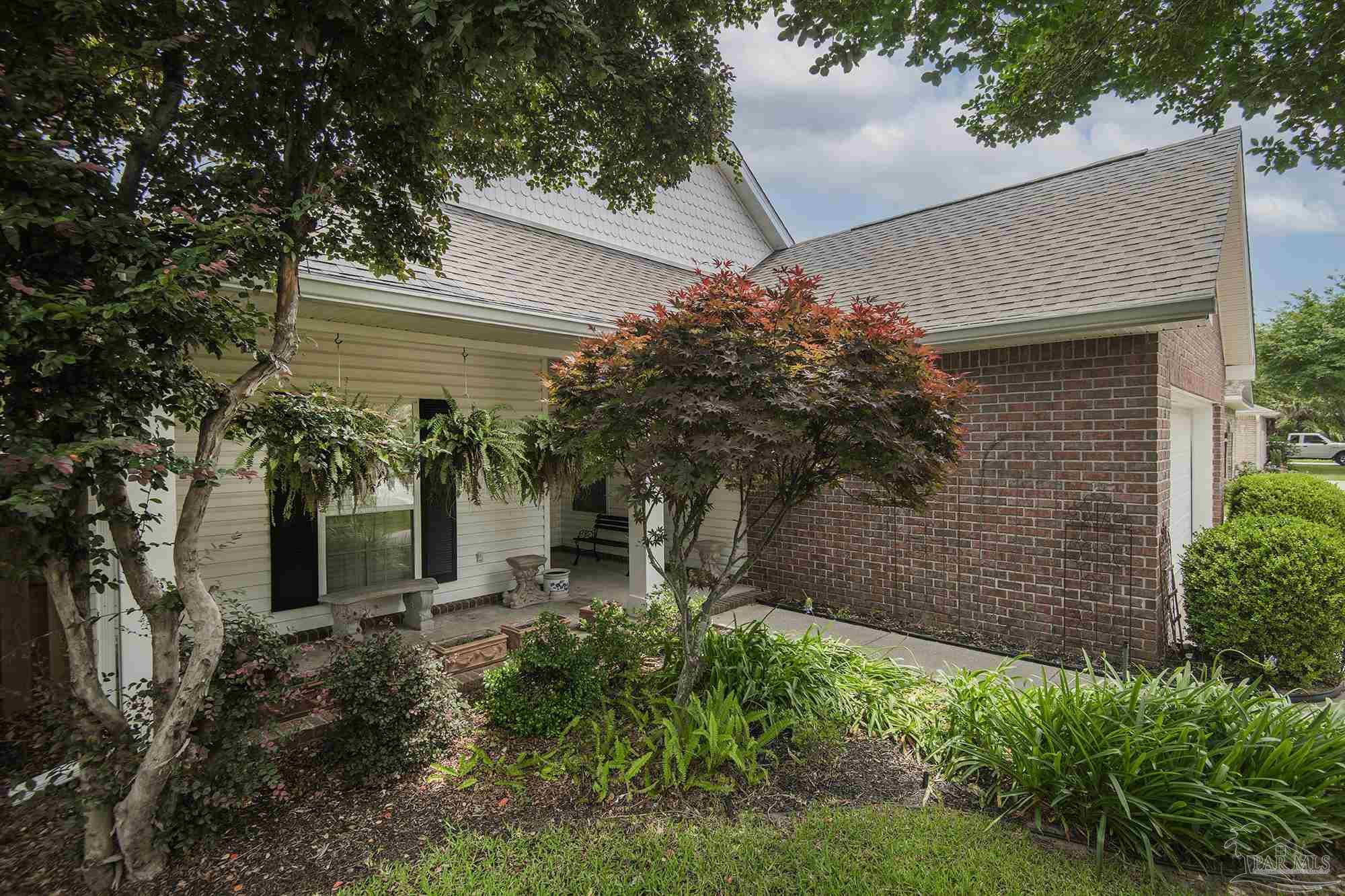3200 Silverleaf Drive Pensacola, FL 32504 - Photo 37 of 38 a yellow house with trees in front of it