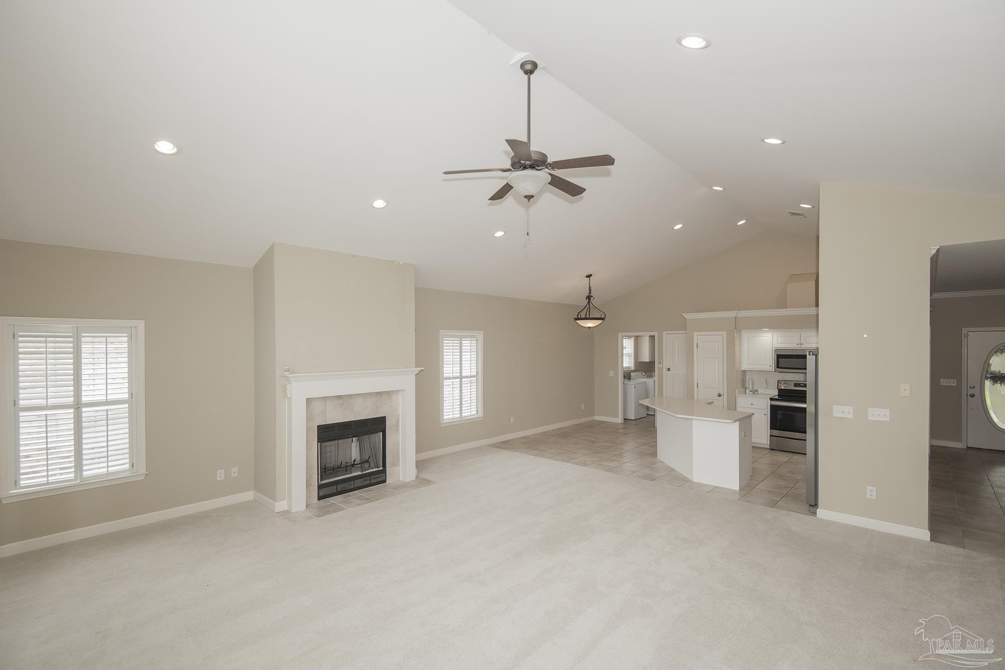 3200 Silverleaf Drive Pensacola, FL 32504 - Photo 6 of 38 an empty room with chandelier fan and fire place