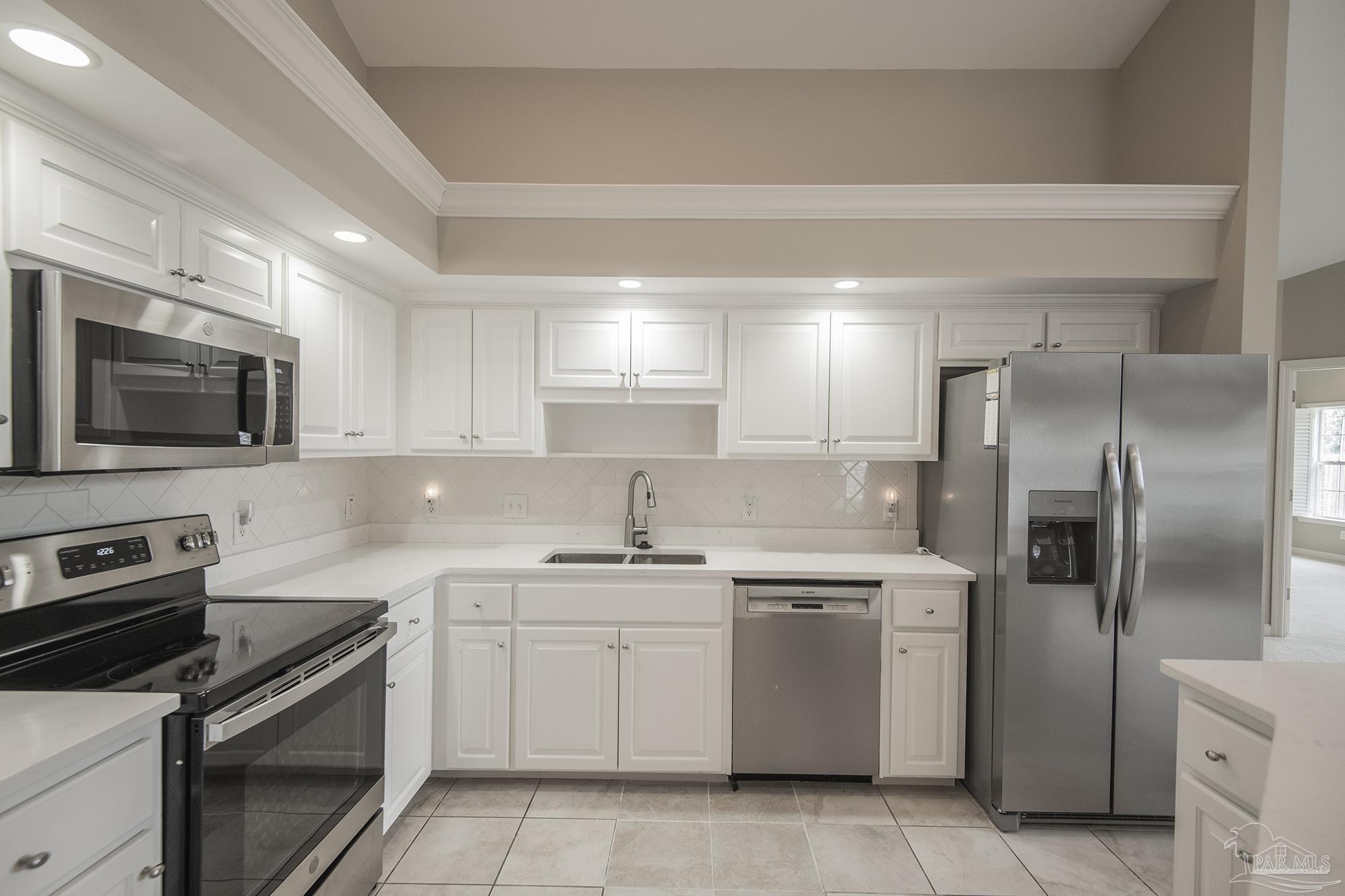 3200 Silverleaf Drive Pensacola, FL 32504 - Photo 7 of 38 a kitchen with a sink stainless steel appliances and cabinets