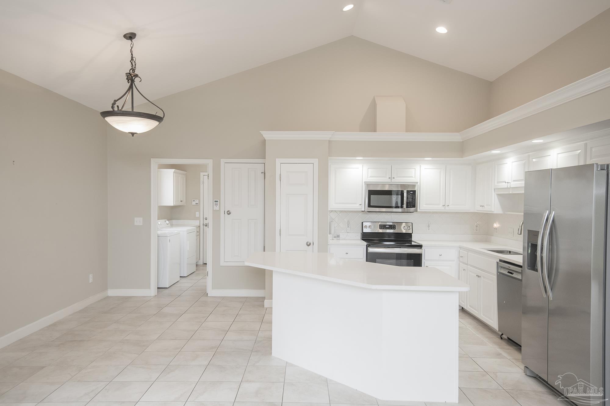 3200 Silverleaf Drive Pensacola, FL 32504 - Photo 8 of 38 a kitchen with granite countertop a refrigerator oven a sink dishwasher and white cabinets with wooden floor