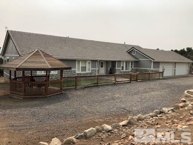 2640 Castle Peak Road Reno, NV 89521 - Photo 1 of 25 a front view of a house with a yard
