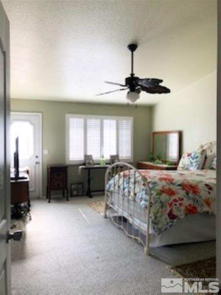 2640 Castle Peak Road Reno, NV 89521 - Photo 11 of 25 a bedroom with a bed and a chandelier