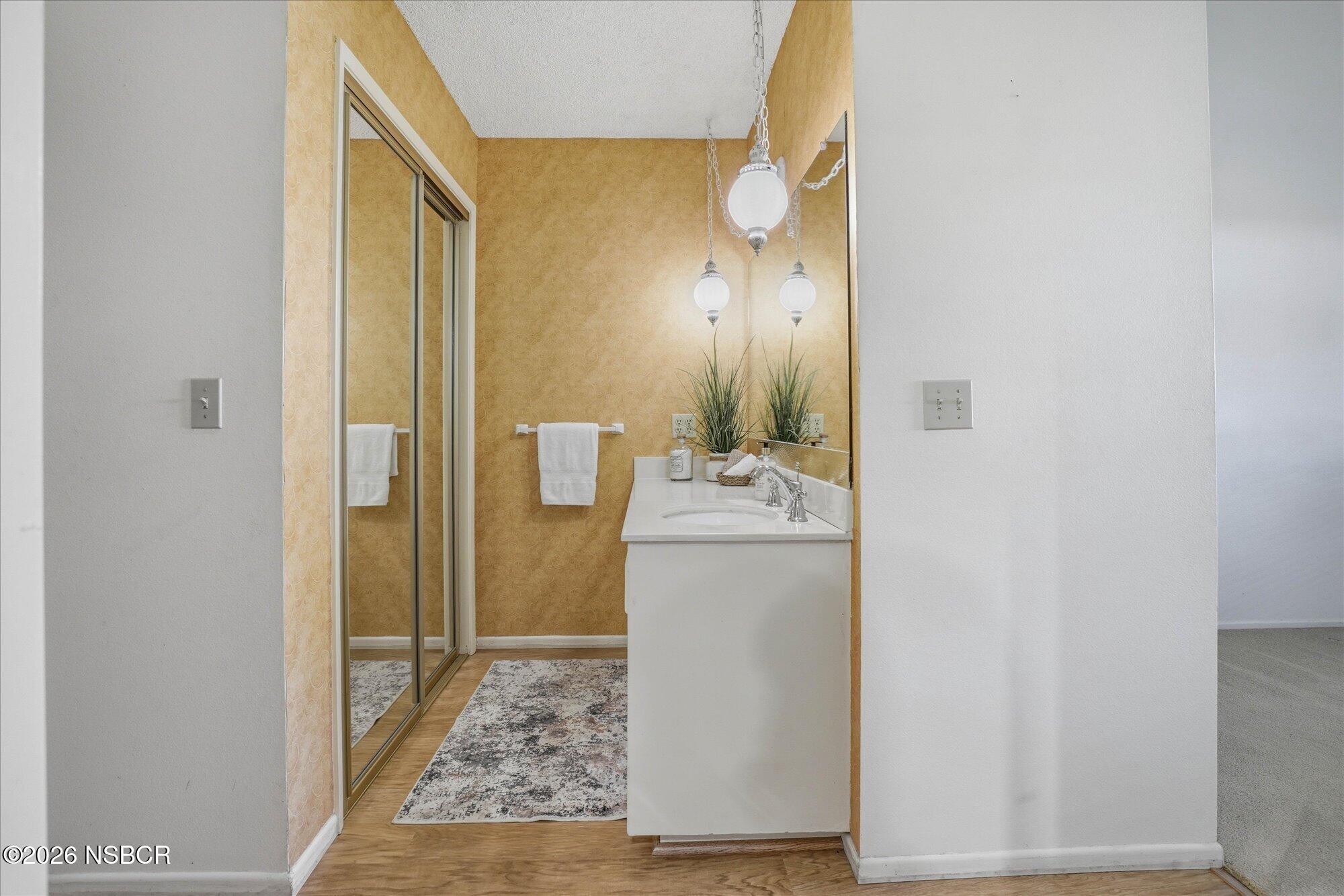 166 Tallyho Road Santa Maria, CA 93455 - Photo 12 of 20 a room view with wooden floor and mirror