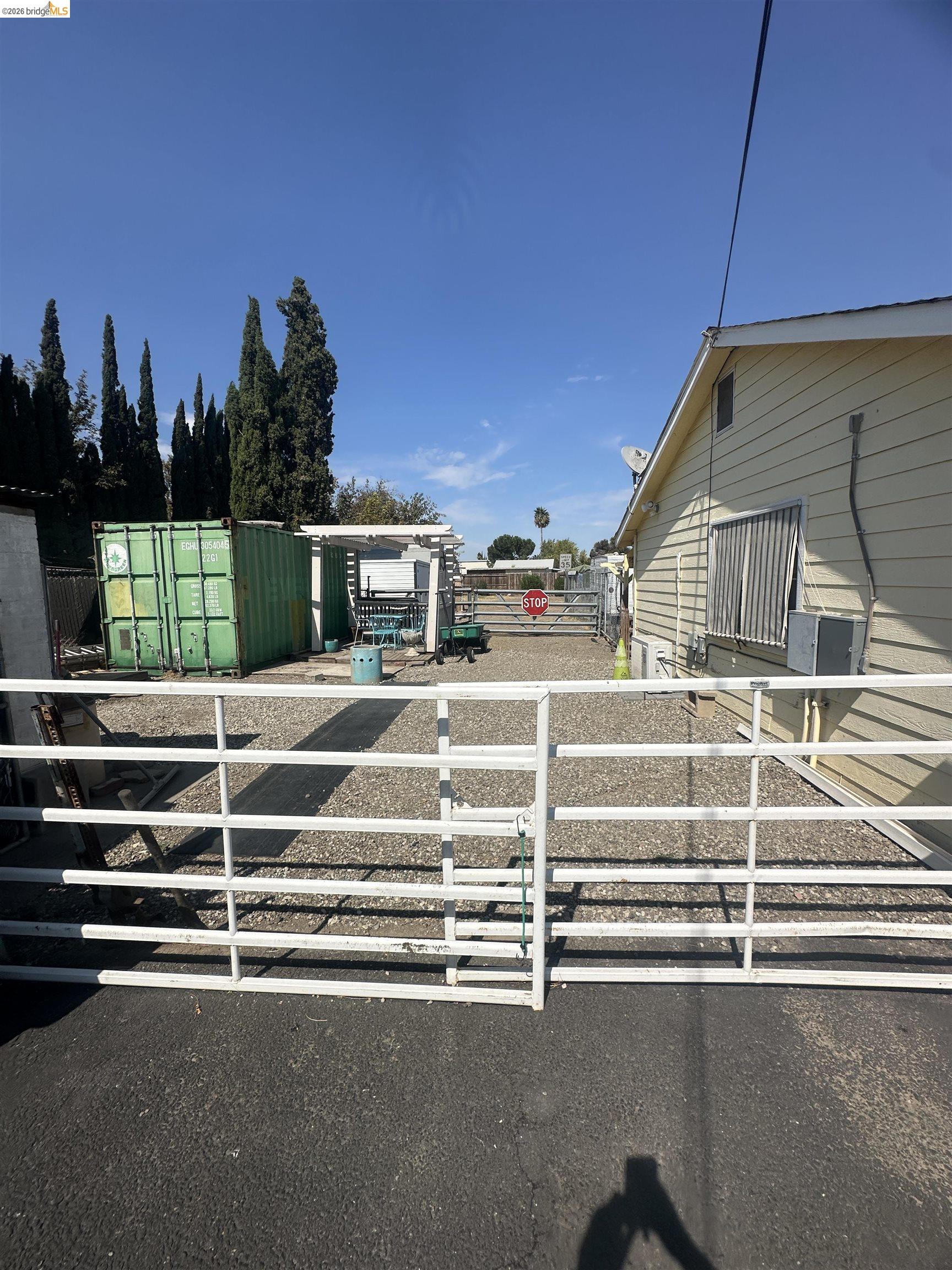 2831 Fabian Road Tracy, CA 95377 - Photo 5 of 23 Gated entry to a gravel courtyard