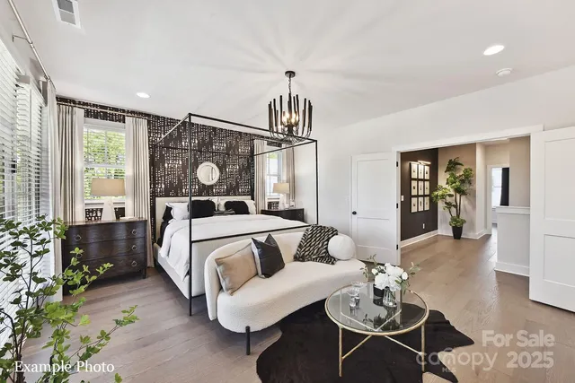 a bedroom with a bed mirror and window